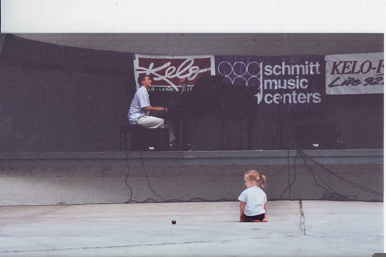 Matthew Mayer performing piano on an outdoor community stage, Sioux Falls, South Dakota, in 1998